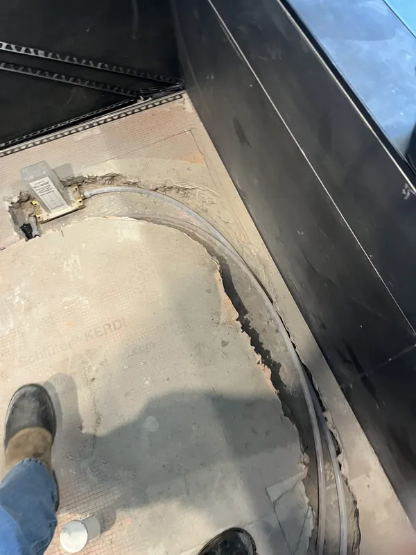 Floor-mount freestanding tub filler valve installed in a slab with supply lines chased into the floor
