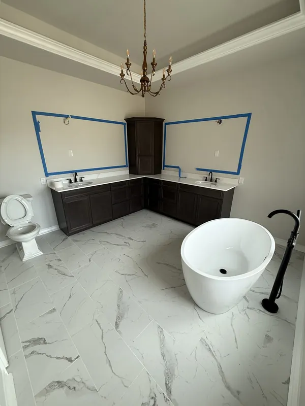 Freestanding soaking tub with floor-mount tub filler