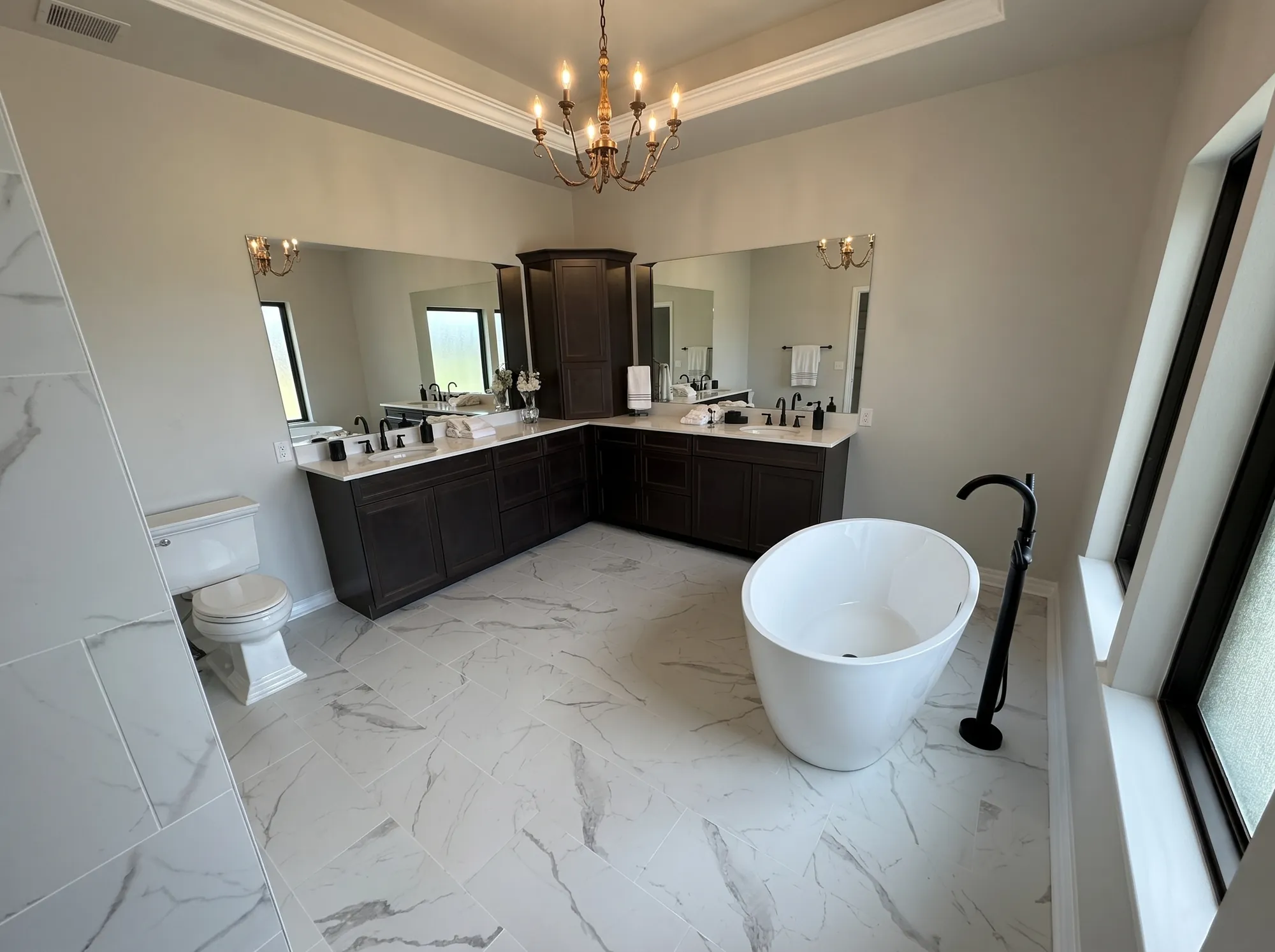 Luxury master bathroom remodel by Pivot Plumbing — freestanding soaking tub, marble floors and custom finishes